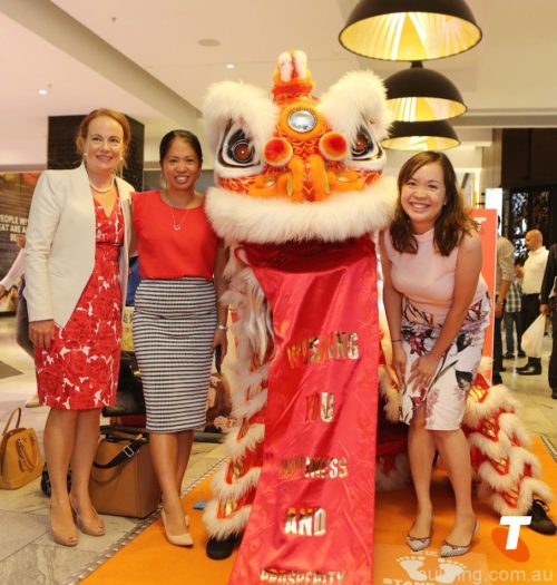 The Telstra team pose with the lion dancers at the Telstra Lunar New Year screen in Sydney's Macquarie Shopping Centre