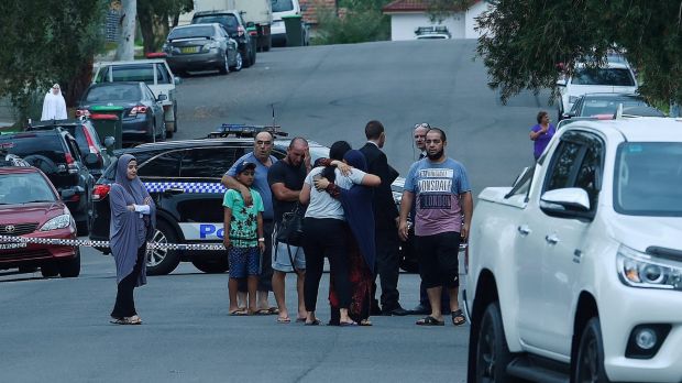People comfort each other at the scene of a fatal stabbing in South Granville.