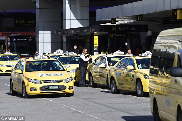 Taxis wait near the new designated pick-up zone for Uber at Tullamarine Airport in Melbourne