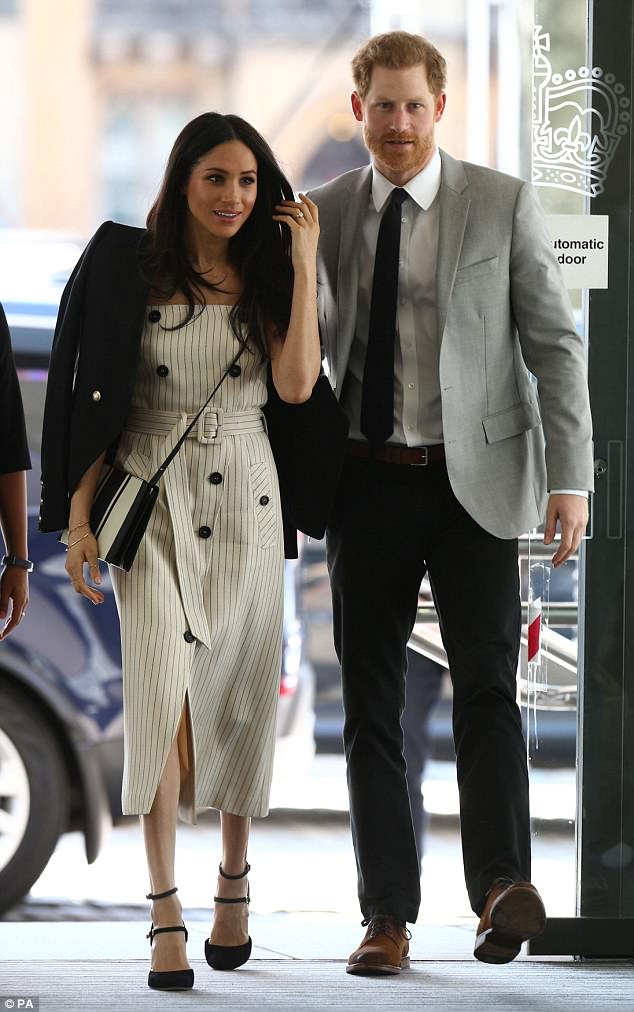 Meghan Markle stepped out on a 25 degree day in London wearing not one but two Australian designers (pictured with Prince Harry)