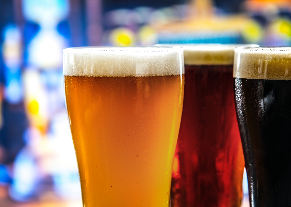 clear drinking glass filled with beer in shallow photo