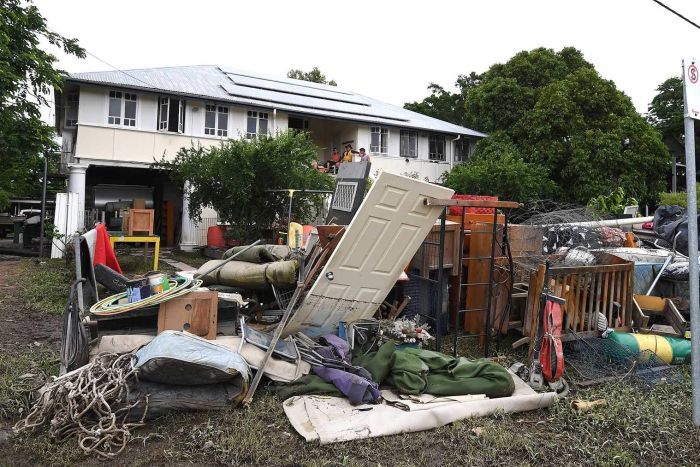 Debris outside a flood-damaged house