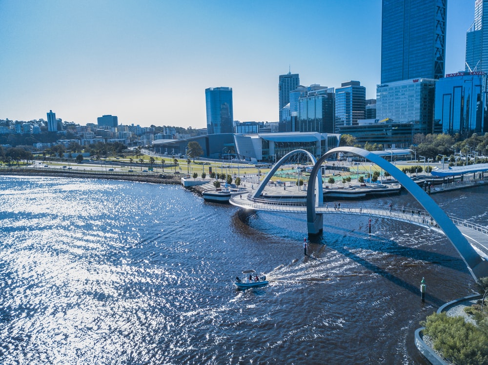 aerial photography of bridge over river near high-rise building