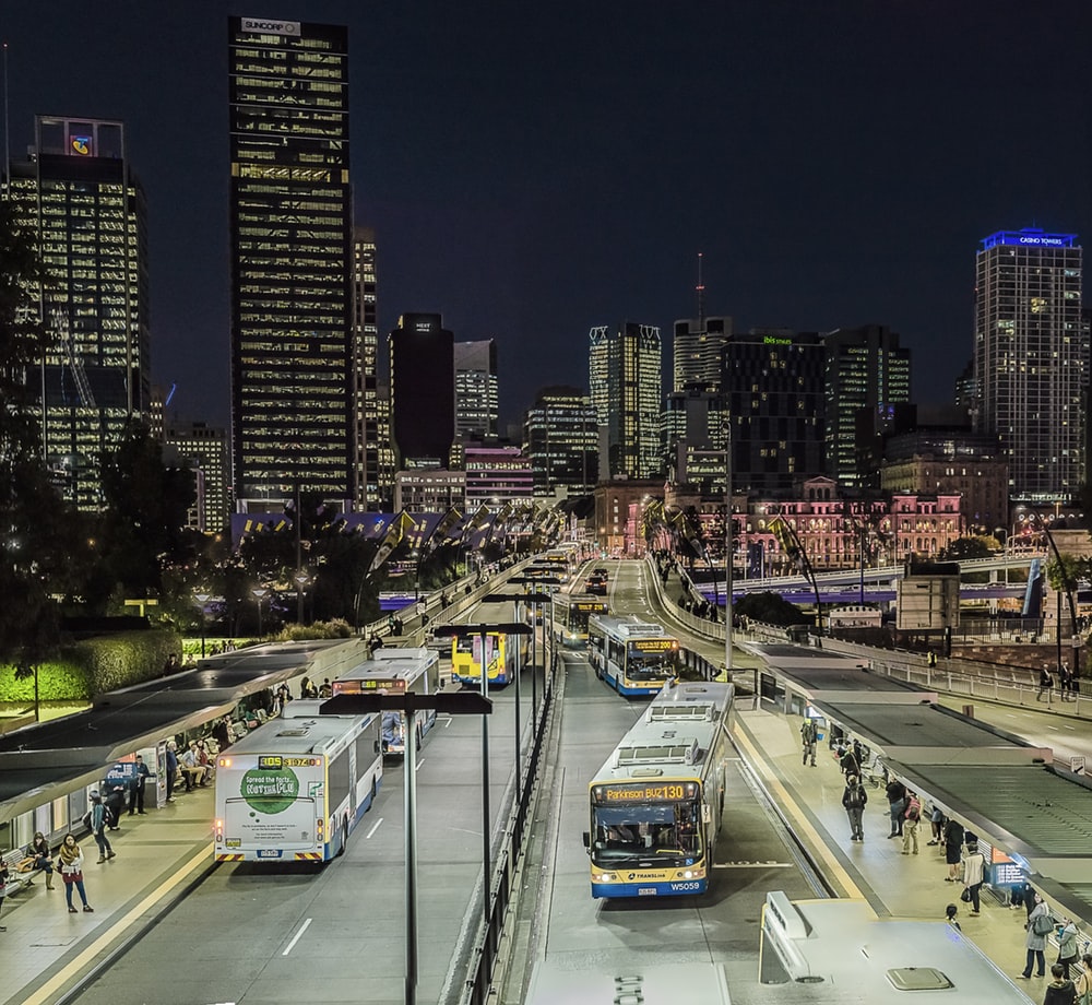 lighted city with busy street and high-rise buildings