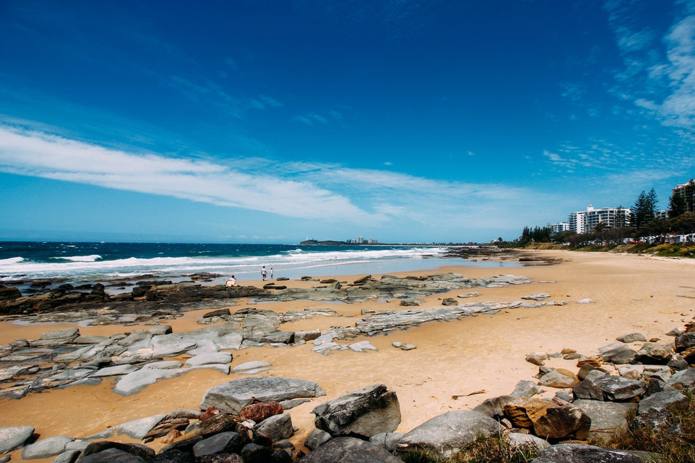rocky shore under clear blue sky during daytime