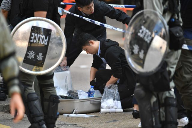 港警11日在西灣河向示威者發射實彈，圖為警務人員調查現場。