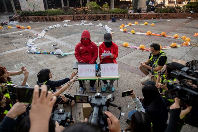 兩名留守理大的示威者經過勸解後答應離開校園。（NICOLAS ASFOURI/AFP via Getty Images）